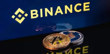 Ethereum coin and Bitcoin on the background of the Binance logo