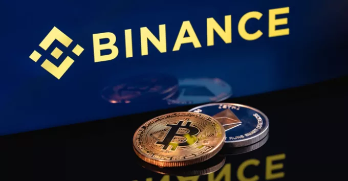 Ethereum coin and Bitcoin on the background of the Binance logo