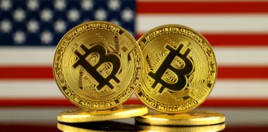 Physical version of Bitcoin and United States Flag
