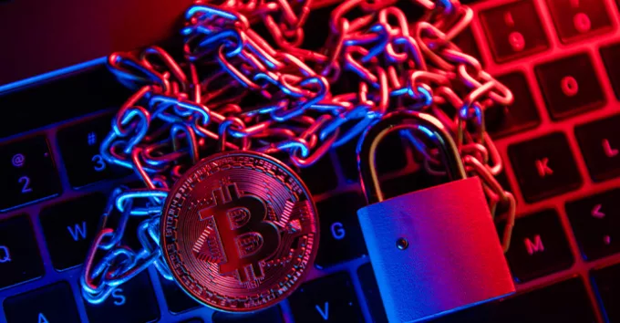 Bitcoin with chain and padlock. Conceptual photography of financial fraud