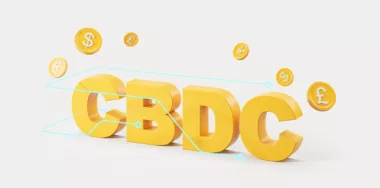 Letters CBDC surrounded by digital dollar, yen, euro and pound coins over white background