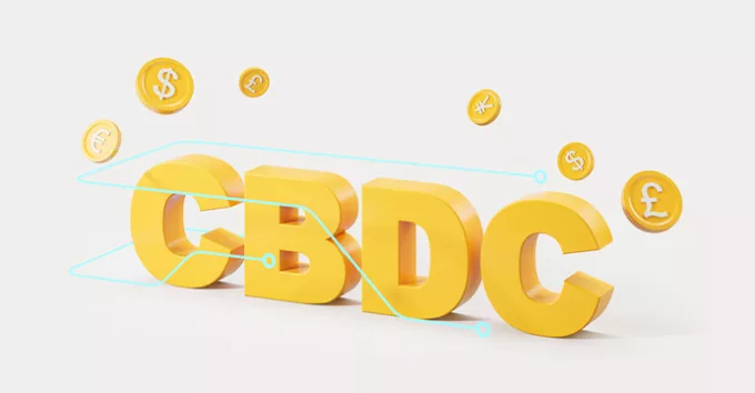 Letters CBDC surrounded by digital dollar, yen, euro and pound coins over white background