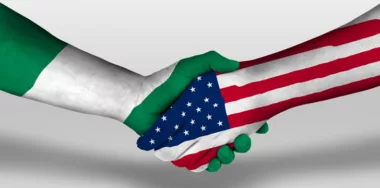 Handshake between Nigeria and USA flags