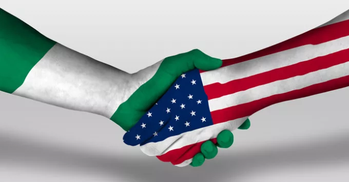 Handshake between Nigeria and USA flags