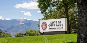 State of Colorado sign with state seal on the corner of S. Academy and E. Fountain Blvds