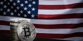 One silver bitcoin and stack of bitcoins over USA flag