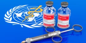 Vaccine bottles with syringe on the World Health Organization flag
