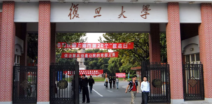 Chinese students walk through an entrance of Fudan University in Shanghai