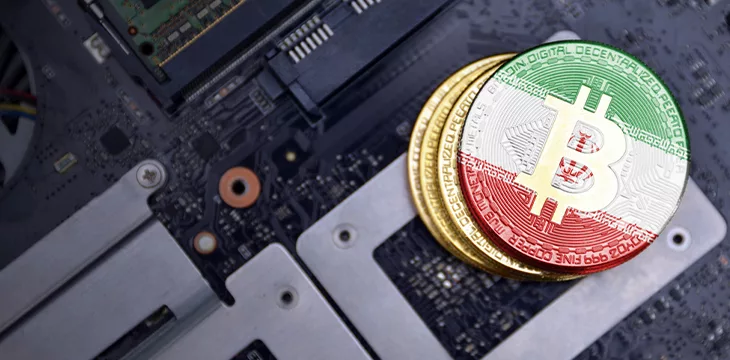 Golden bitcoins with flag of Iran on a computer electronic circuit board