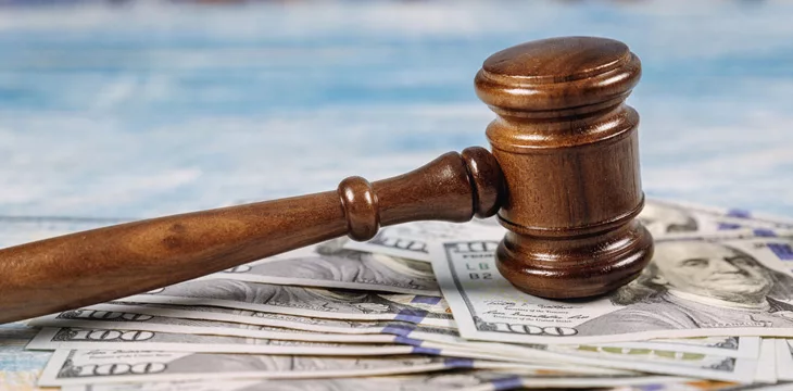 Court gavel and money on blue background