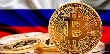 Gold coin with Russian flag in the background
