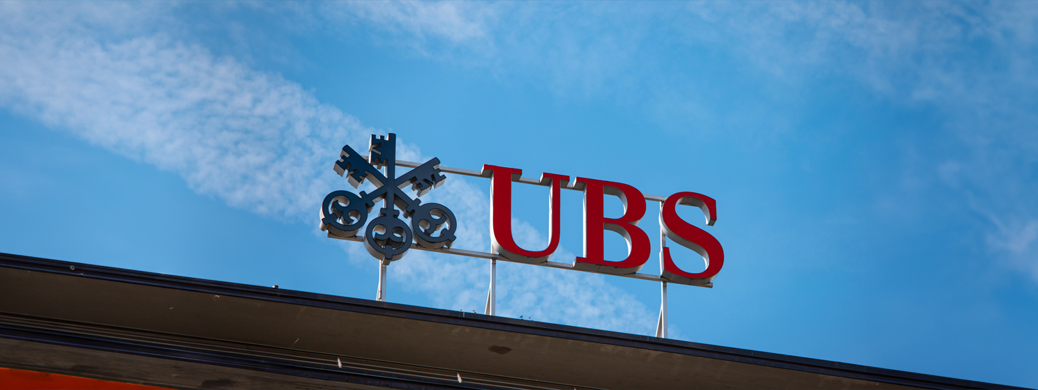 Large red UBS Swiss bank sign on a building