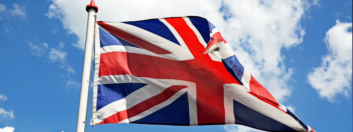 UK flag over blue sky background