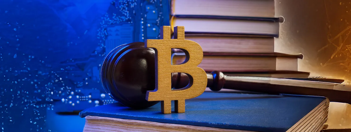 Bitcoin sign and gavel on a book