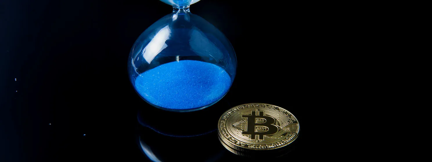 Hour glass and BTC coin over black background