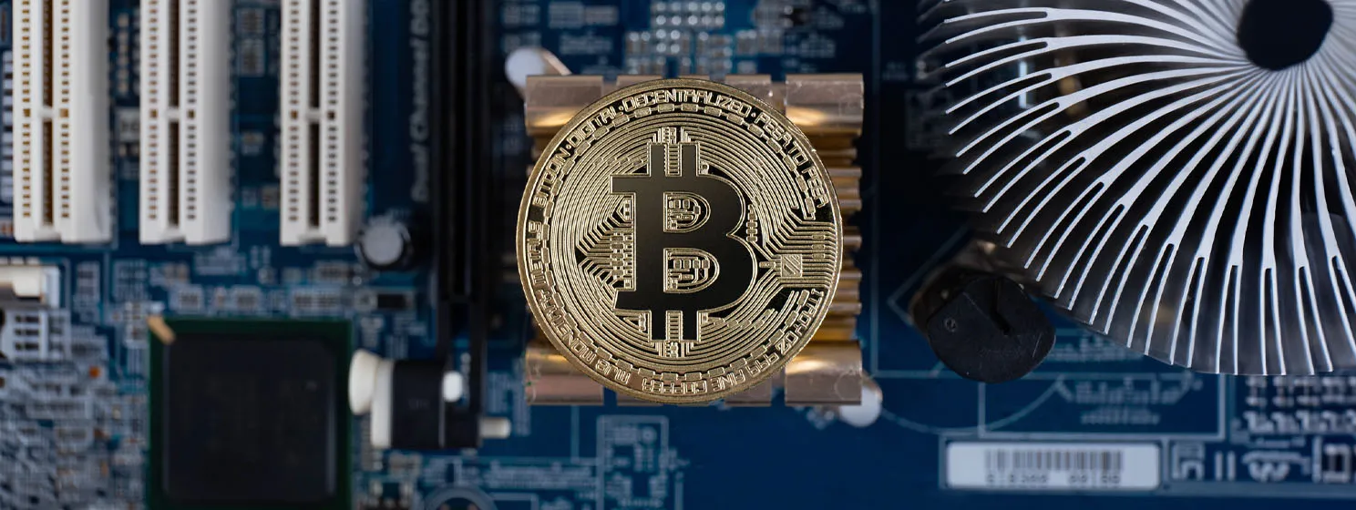 BTC coin over motherboard background