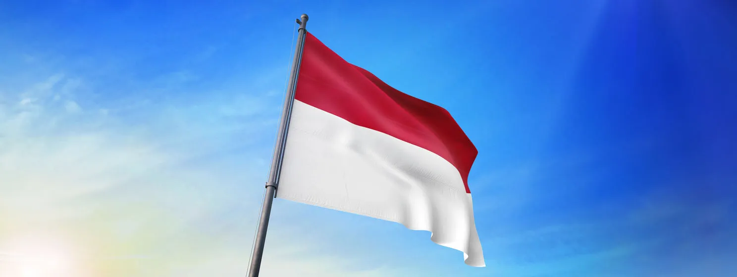 Indonesia flag waving on the blue sky