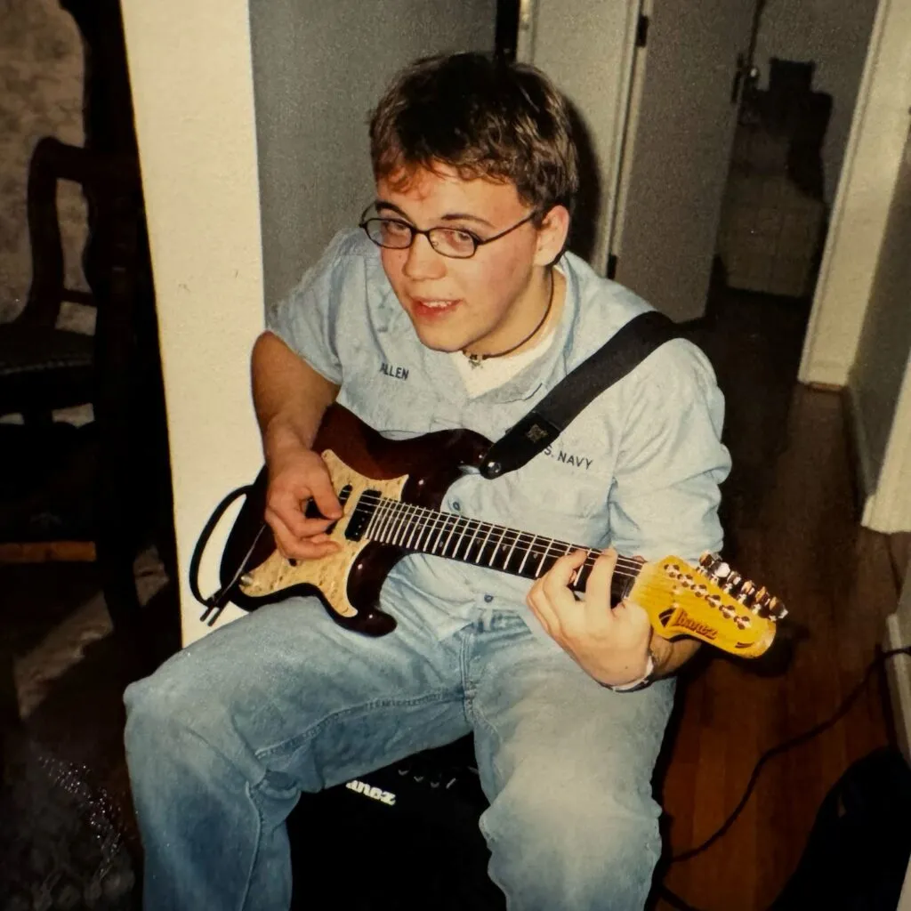 A vintage photo of a man holding a guitar