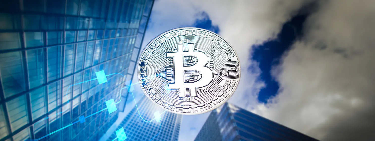 Silver BTC coin over high buildings