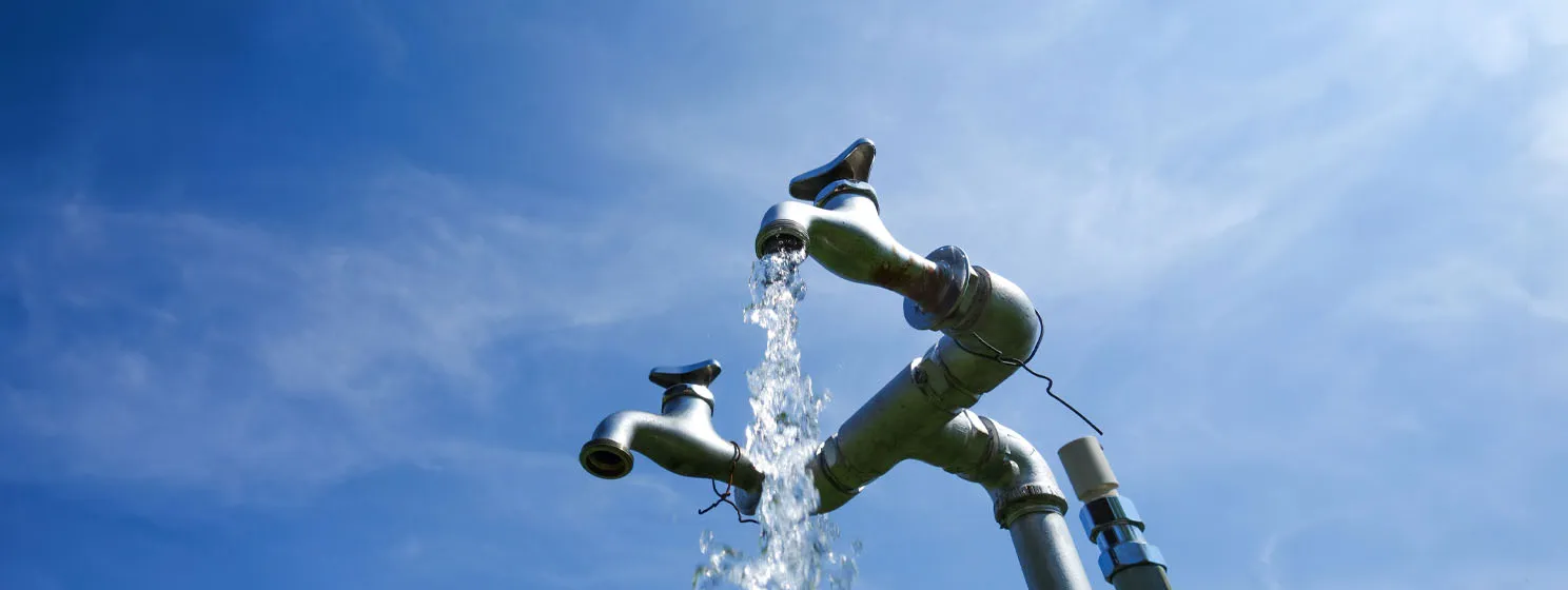 Water faucet with blue sky background