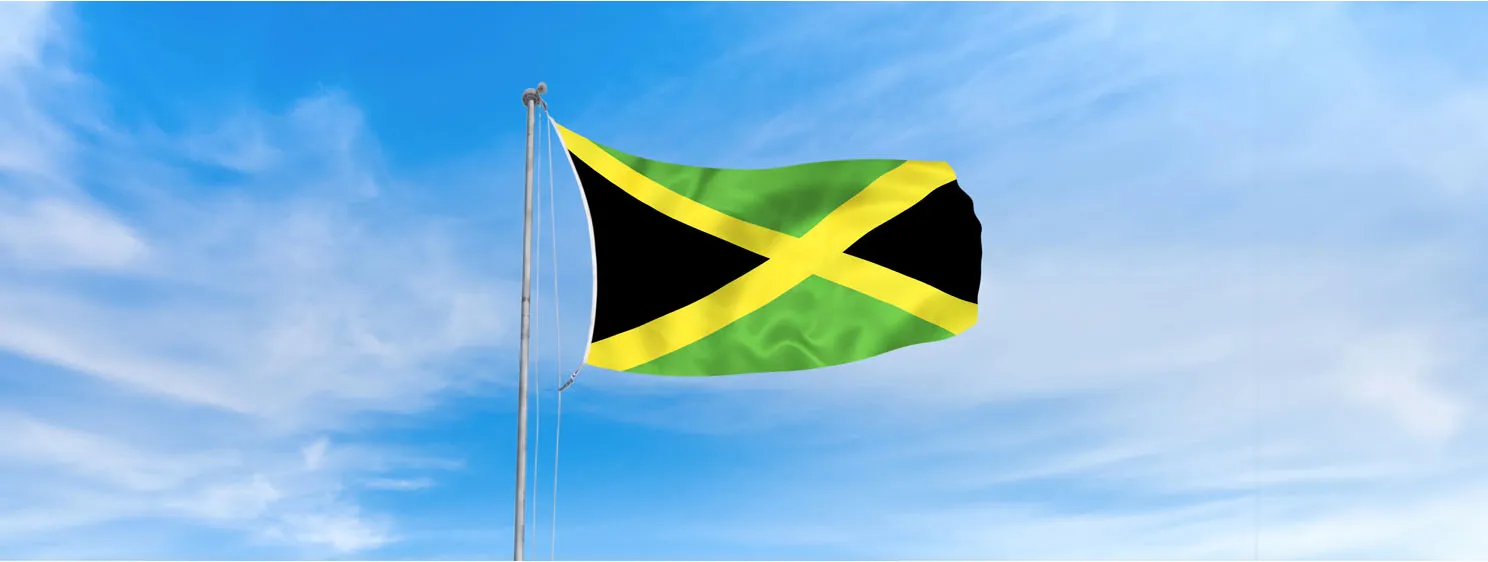 Jamaica flag over blue sky background