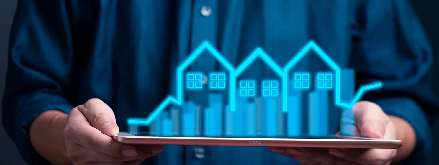 Person holding a tablet with digital projection of real estate investment