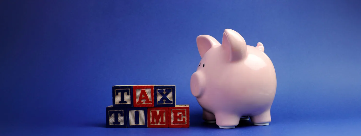 tax time letter blocks and a piggy bank