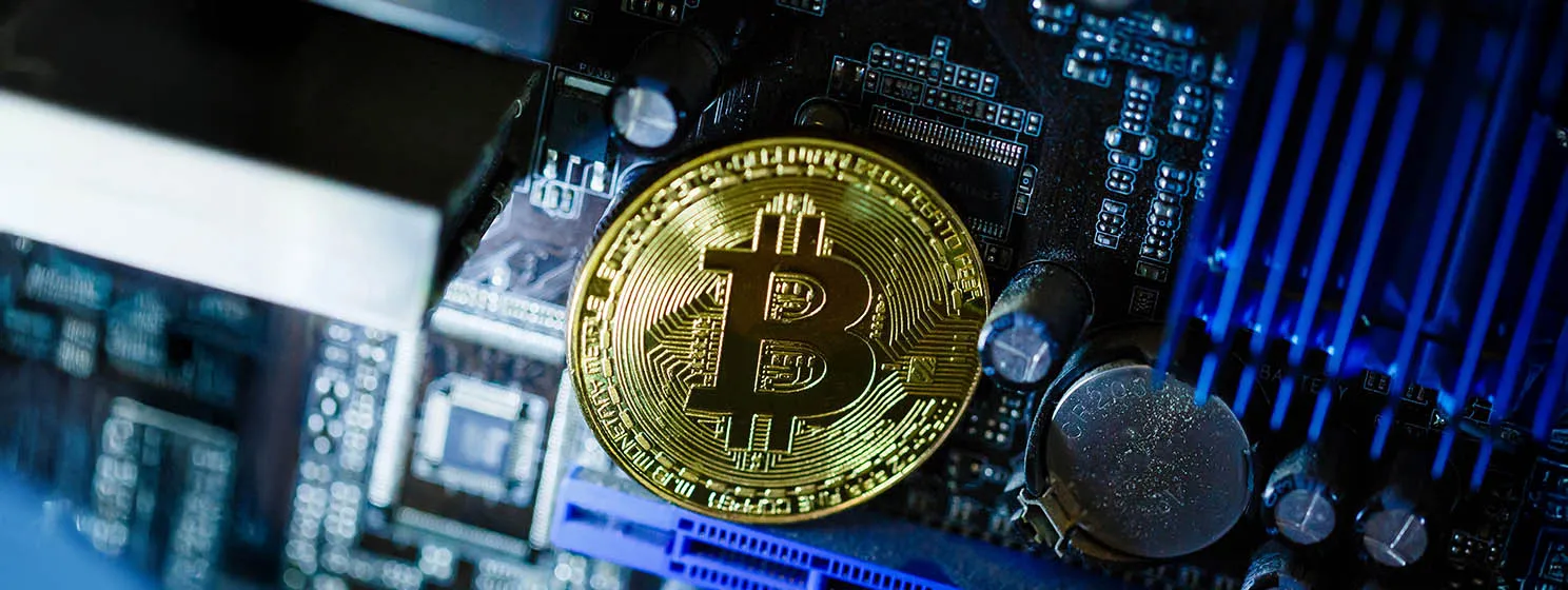 Gold coin of crypto currency bitcoin on computer network chip toned.