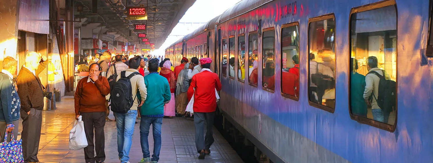 People walking alongside the Jaipur, India Railway Train Station.