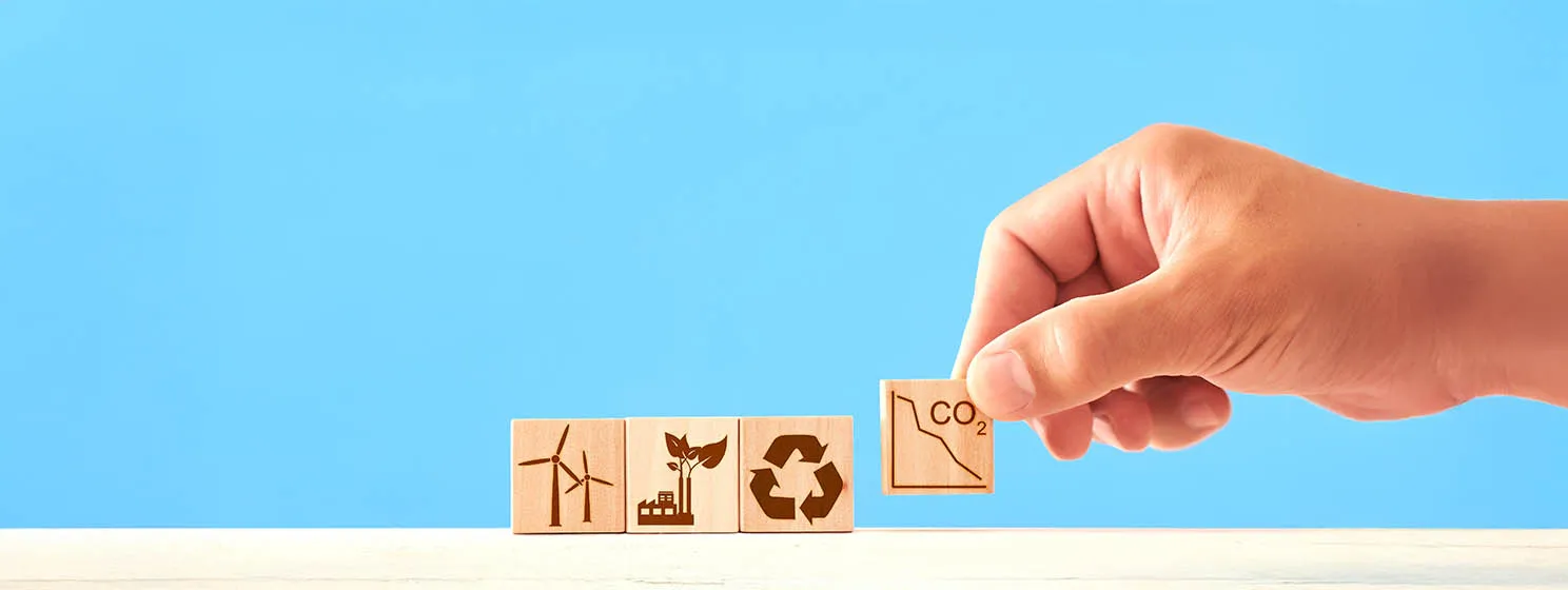 Net zero and carbon neutral concept. wooden cubes with icons - renewable energy, co2 emissions reduction, green production, waste recycling.