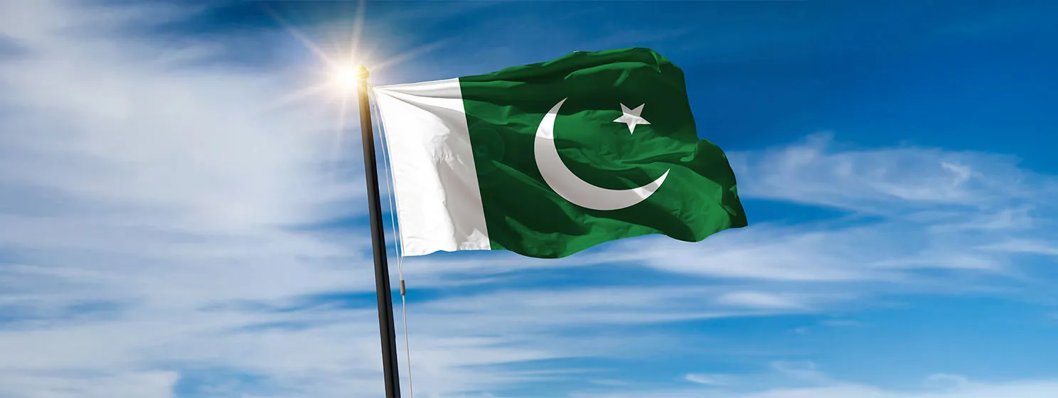 Pakistan national flag waving in beautiful clouds.