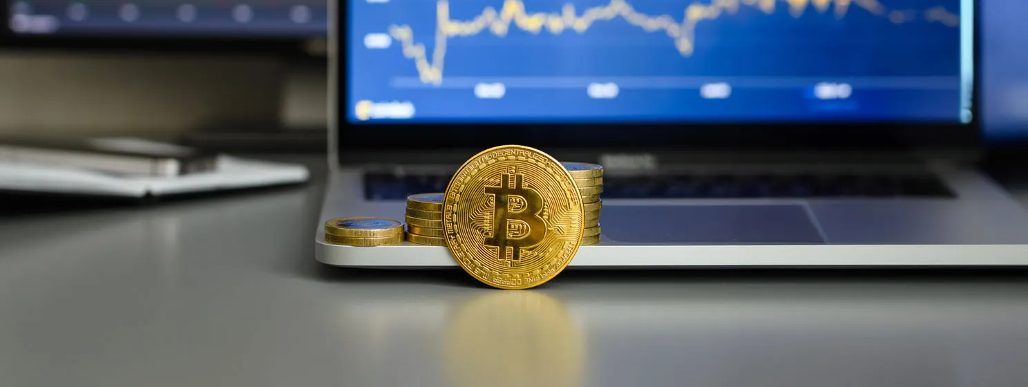 Bitcoin coin against the background of growing income graphs on monitors
