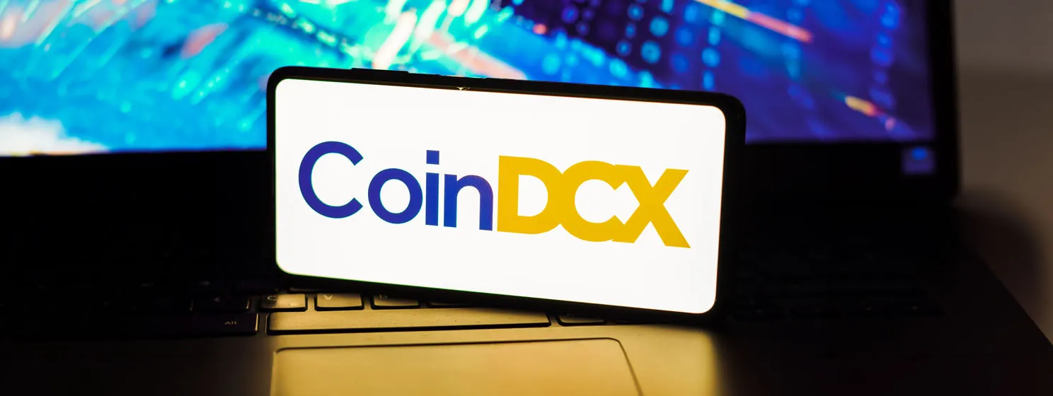 CoinDCX logo on a smartphone