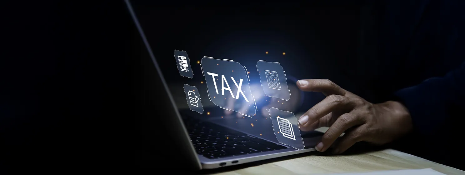 Businessman pointing to tax icon in a laptop screen