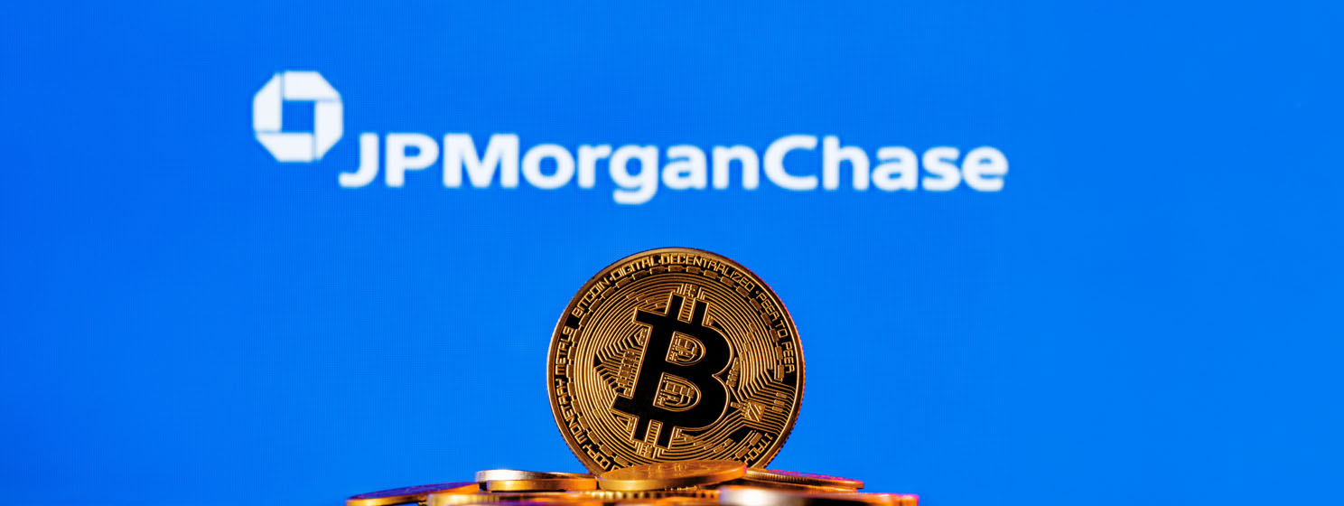 Golden bitcoin in a pile of coins on the background of JPMorgan Chase bank logo