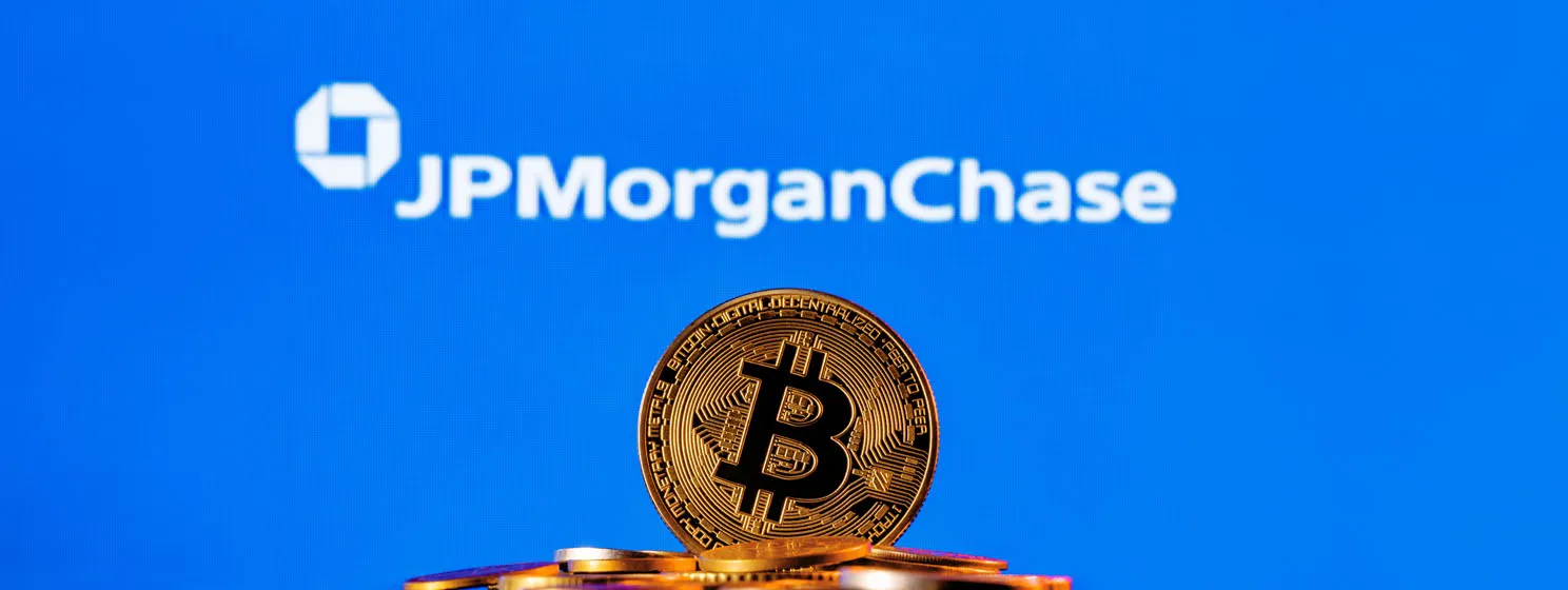 Golden bitcoin in a pile of coins on the background of JPMorgan Chase bank logo