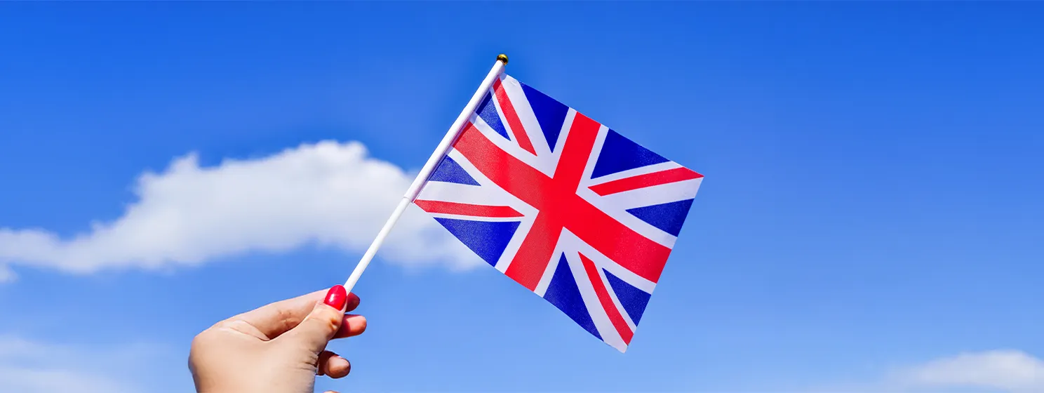 Hand holding a flag of Great Britain