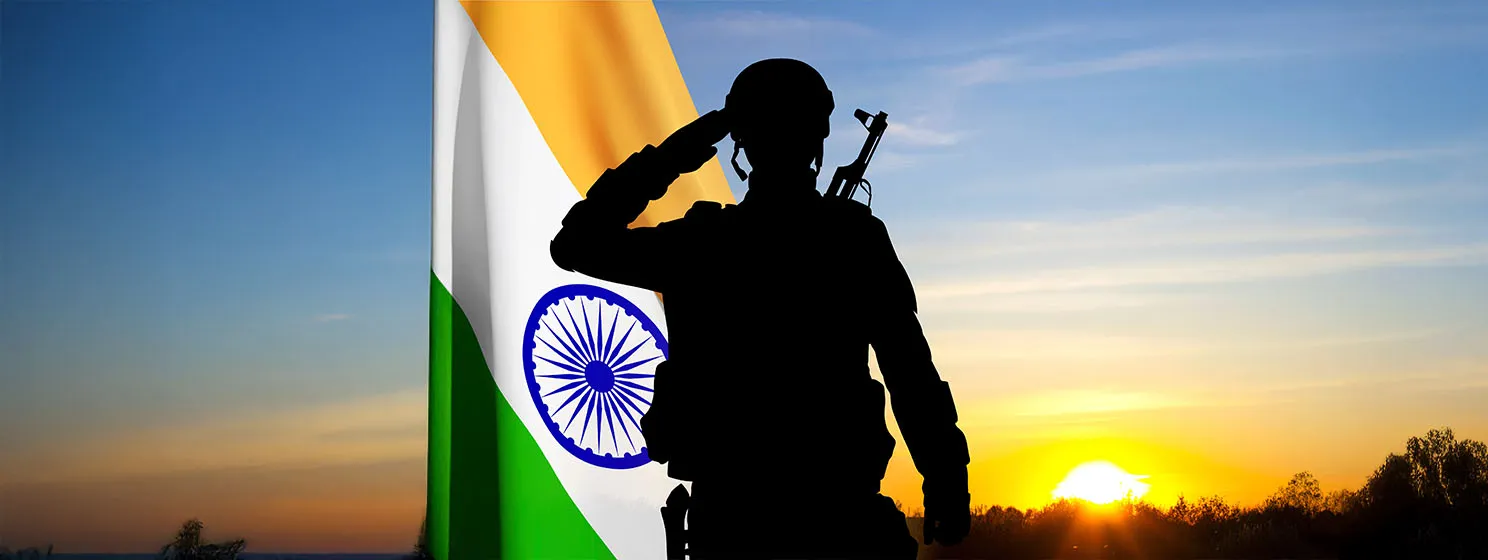 Silhouette of a soldier saluting with India flag on a background the sunset.