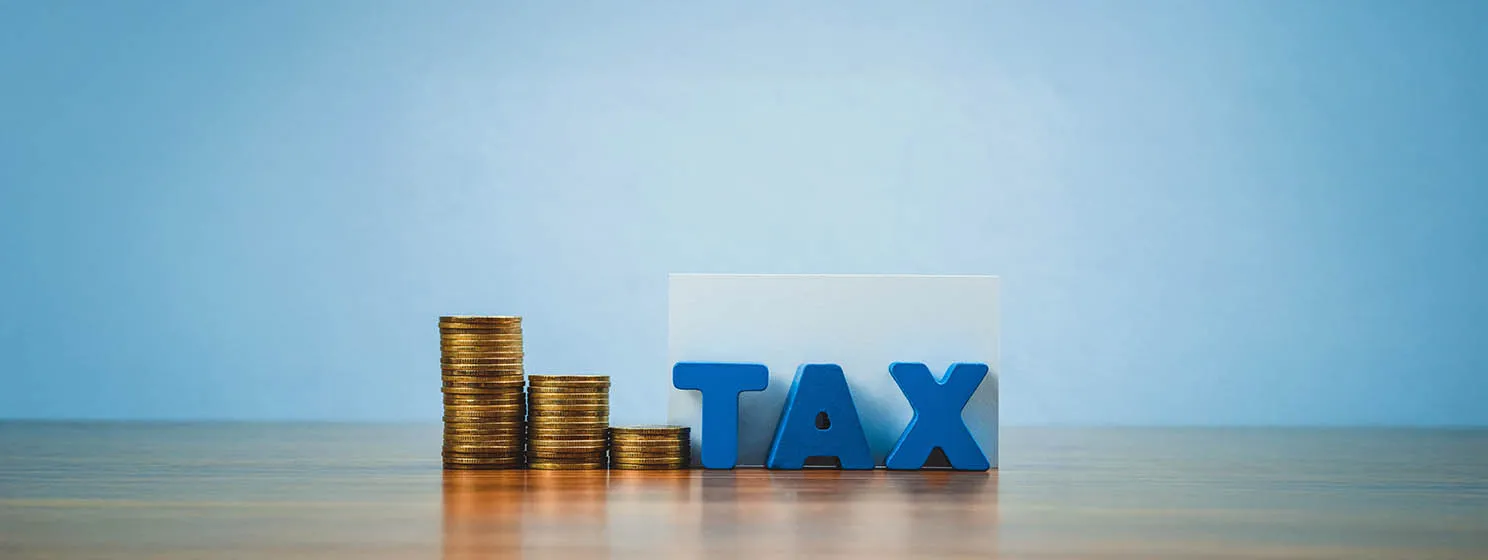 TAX concept. TAX alphabet with stack of coin and business card or name card on wooden working table, business and financial concept idea.
