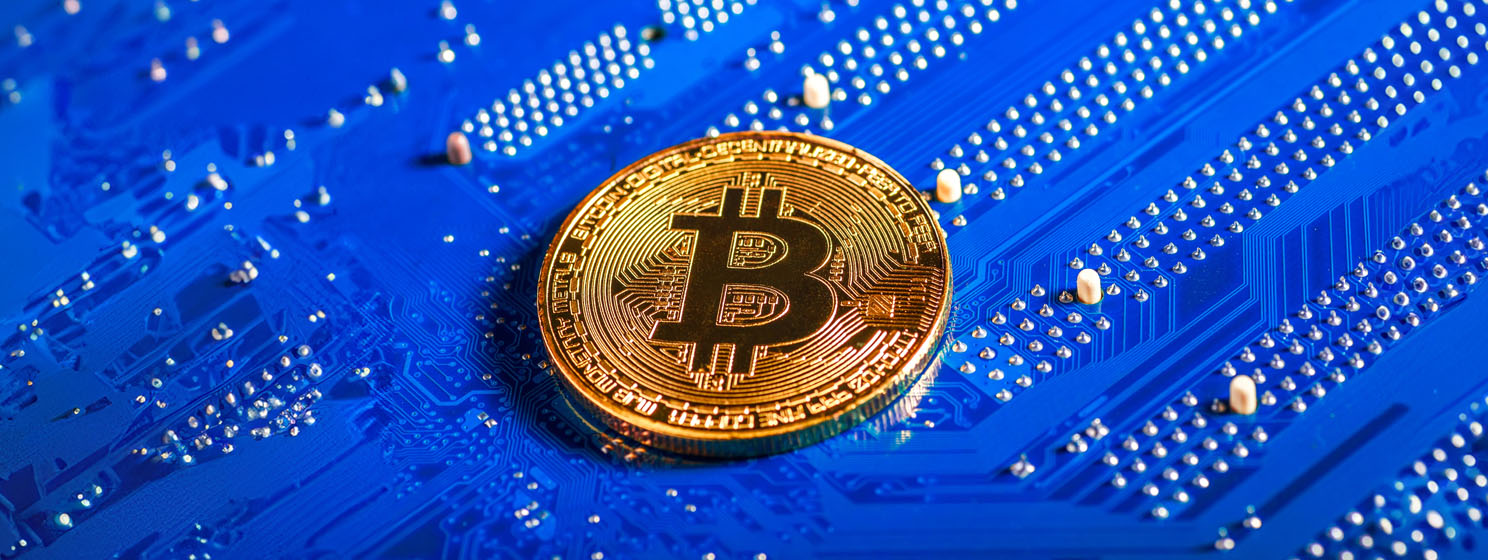Golden Bitcoin Cryptocurrency on computer circuit board
