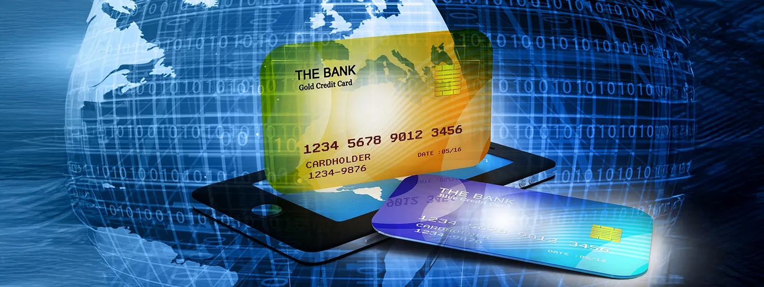 Mobile smart phone with credit cards over a holographic globe with binary codes around its grid.