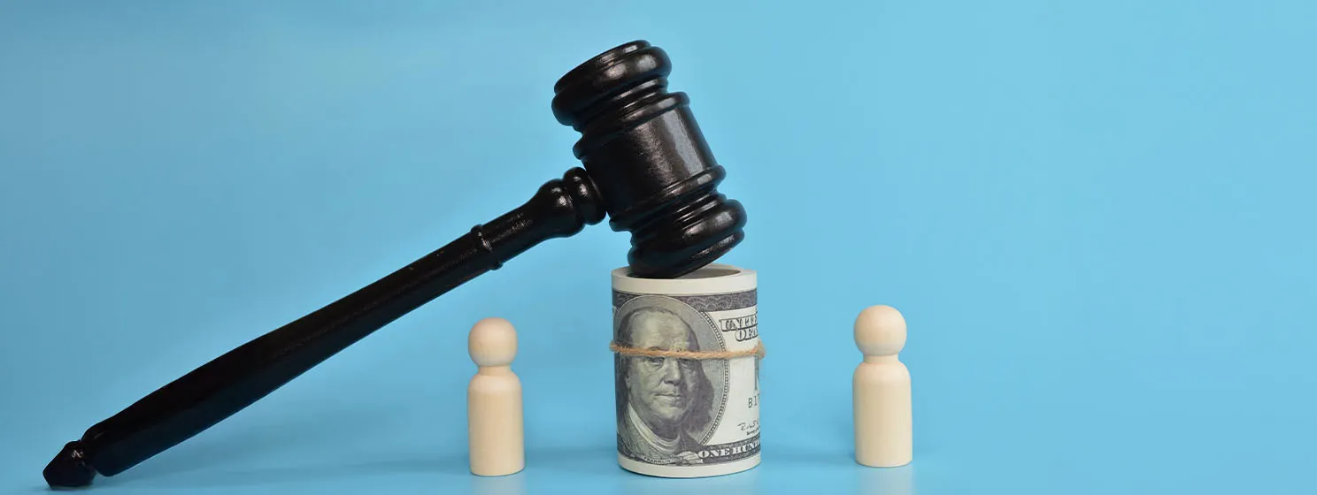 Pawn figure standing with judge gavel and money banknote.