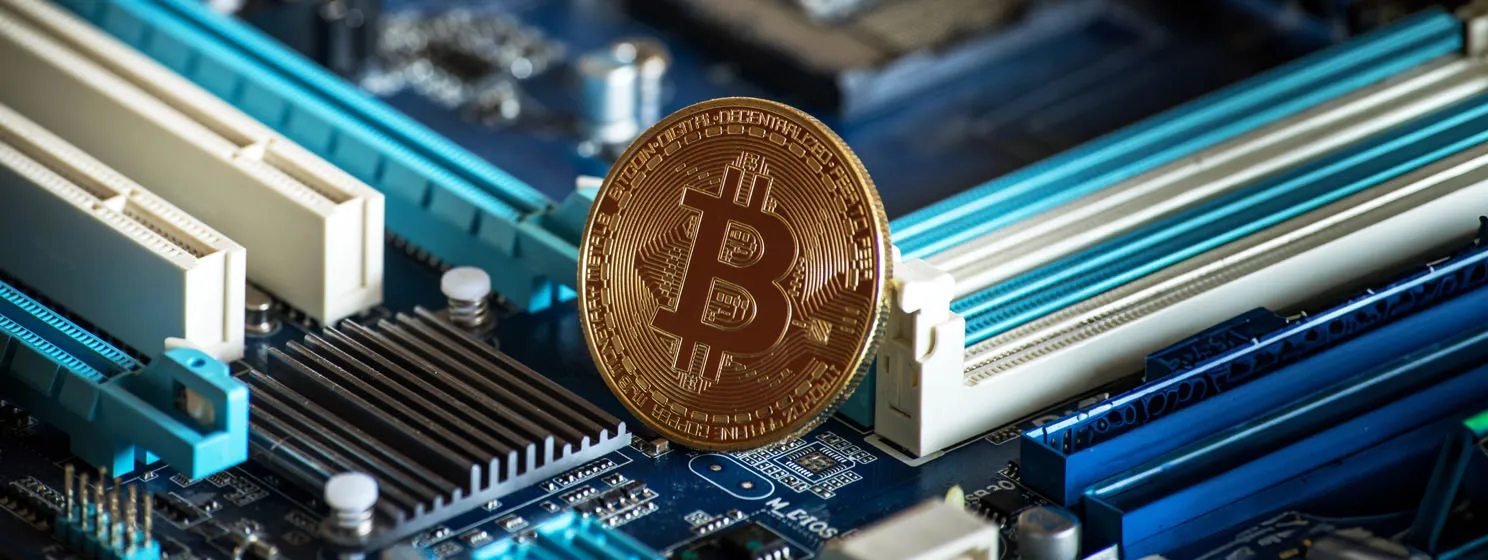 BTC bitcoin coin on motherboard