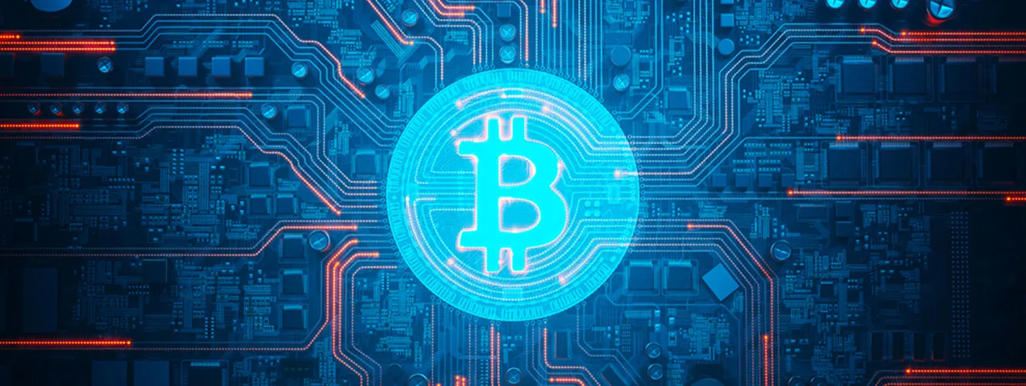 Bitcoin symbol shining on a detailed circuit board