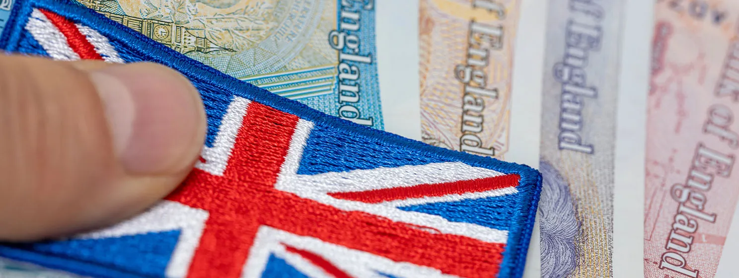 Great britain money, great britain flag and british pounds held in hand