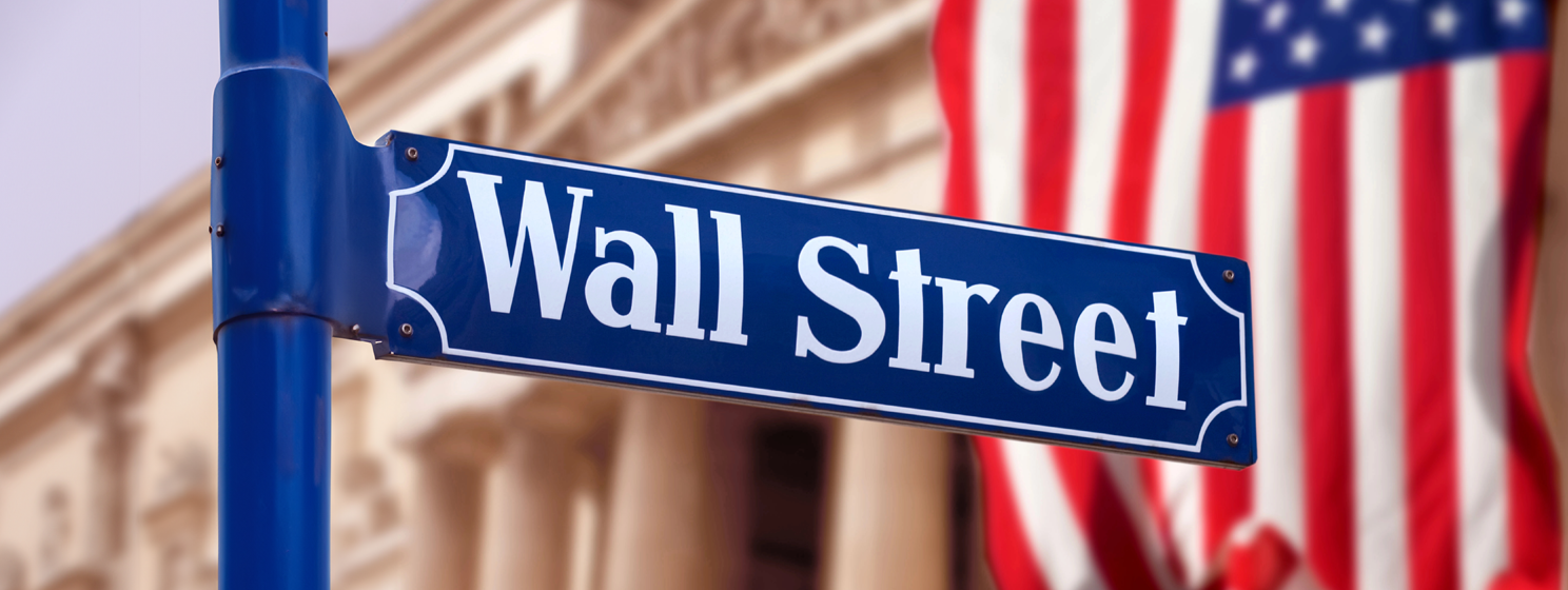Wall Street sign with US flag in the background