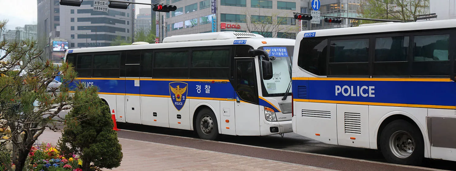 Police buses parked in street of downtown Seoul, South Korea.