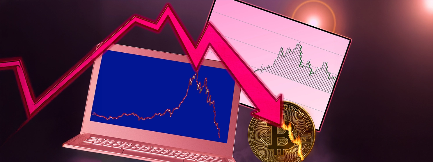 Bitcoin coin in flames as market crash with laptop graph.