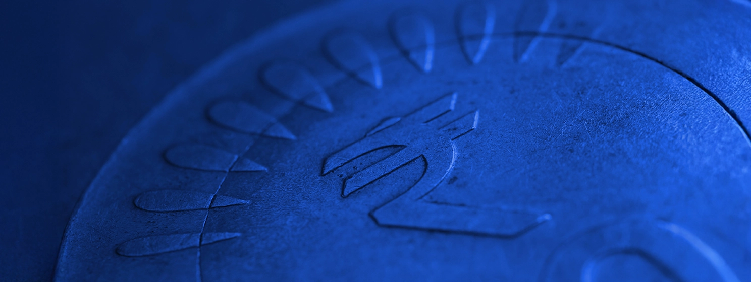 Translation: rupee. Fragment of Indian 10 rupee coin with a national currency symbol close-up.