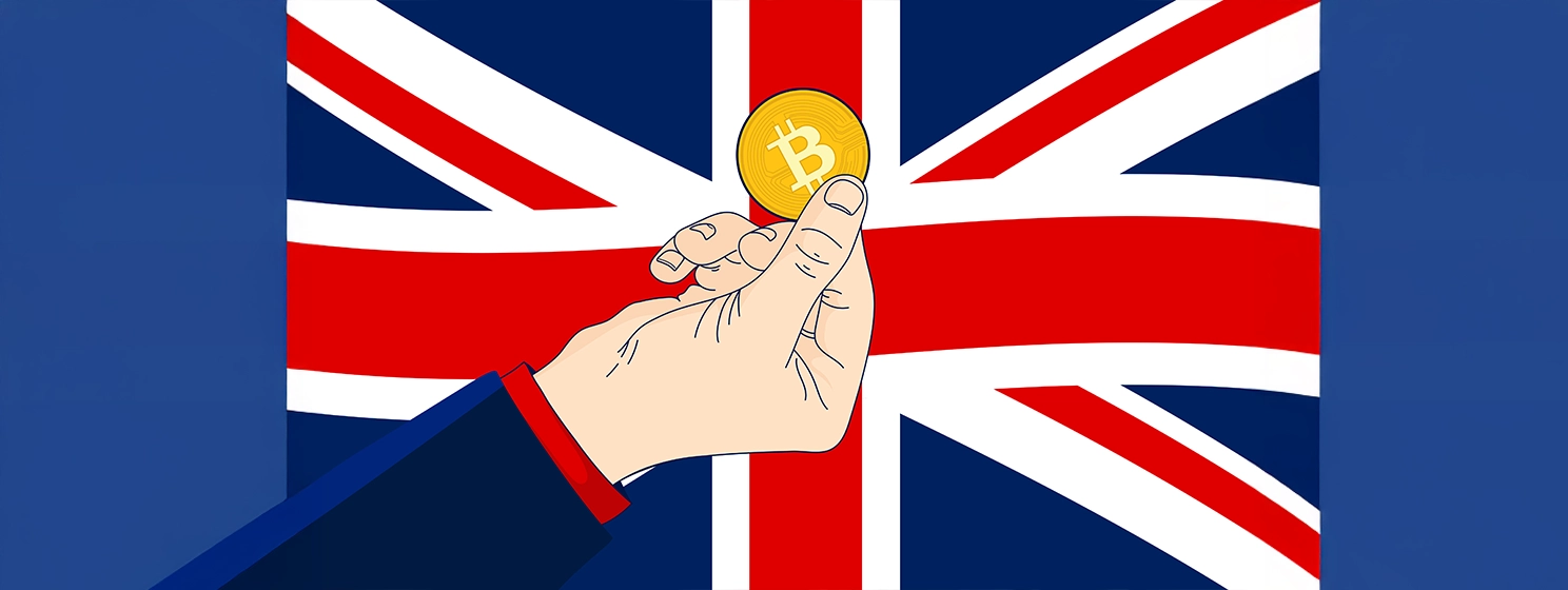 Hand holding coin in front of the British flag Union Jack.
